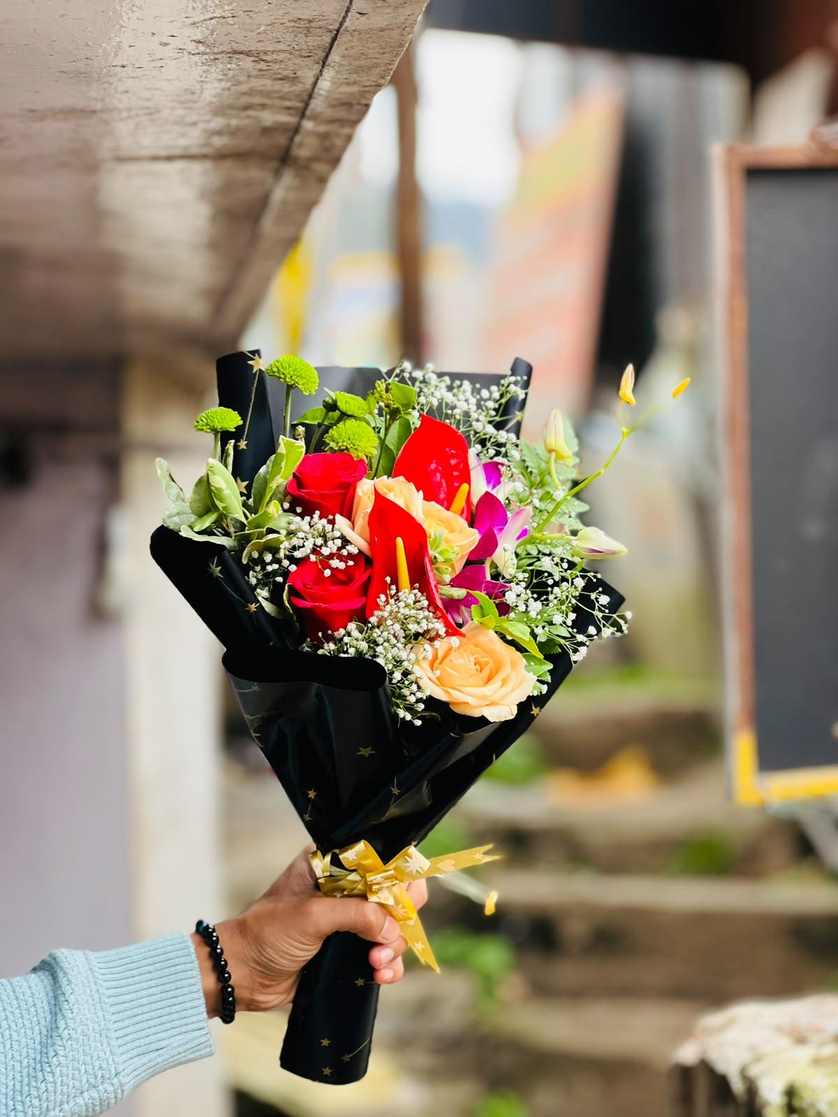 Exotic red anthuriums, peach roses, orchids and button chrysanthemums in Ooty