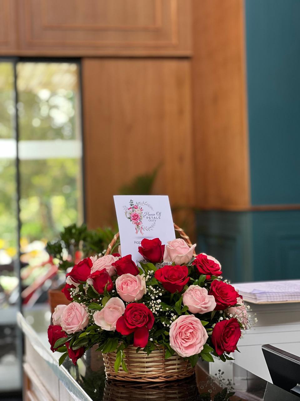 Signature House of Petals rose basket with official greeting card in Ooty
