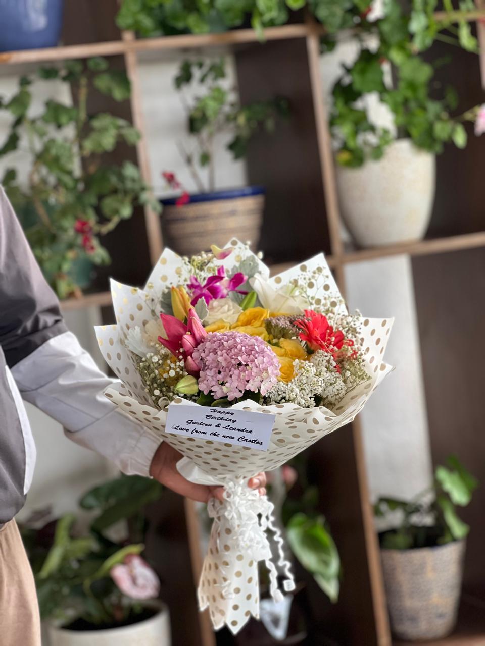Soft lavender hydrangea blossom with pink lilies, yellow roses and gold polka wrap in Ooty